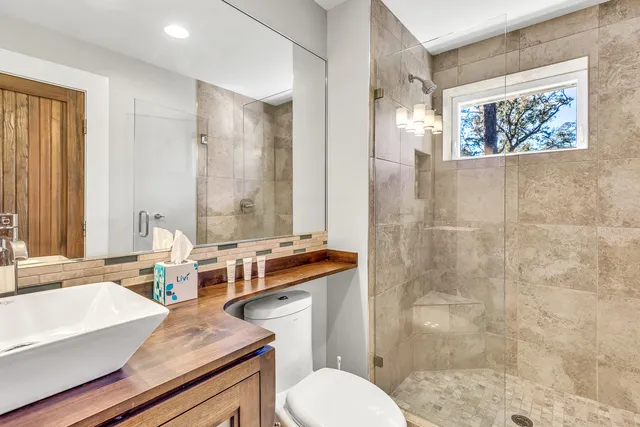 a bath room with a toilet a sink and a bath tub