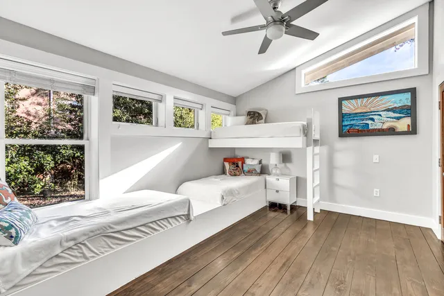 a bedroom with furniture and a large window