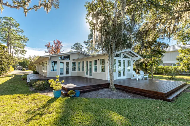 a view of a house with backyard and sitting area