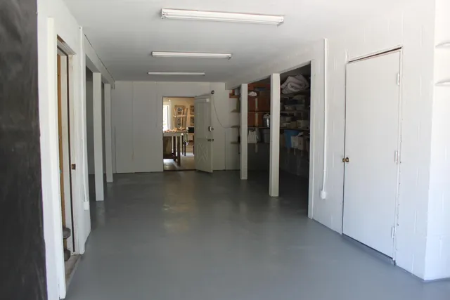 a view of a hallway with wooden shelves