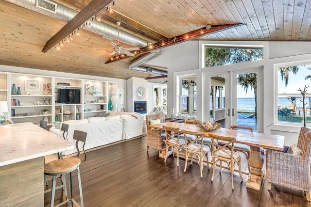 a living room with furniture a wooden floor and next to a window