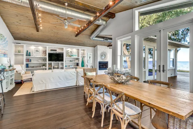 a living room with stainless steel appliances kitchen island granite countertop furniture and a wooden floor