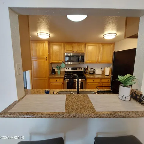 a kitchen with a refrigerator sink and stove