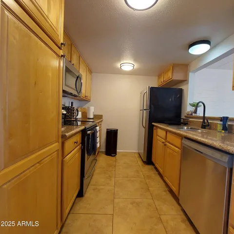 a kitchen with a sink window and cabinets