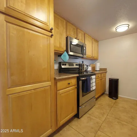 a bathroom with a granite countertop sink a toilet and mirror