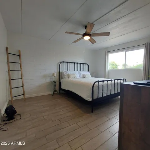a bedroom with a bed and window