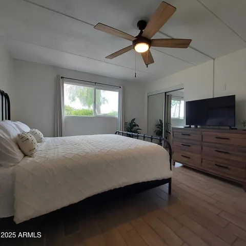 a large bedroom with a bed and a chandelier