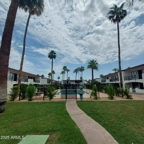 a view of a brick house with many windows