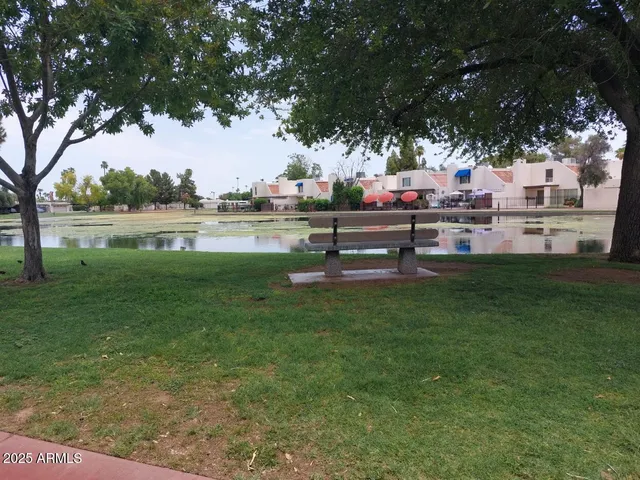 a view of green field with trees around