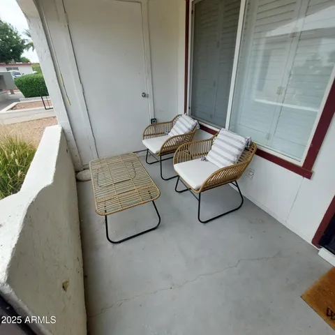 a living room with furniture and a lamp