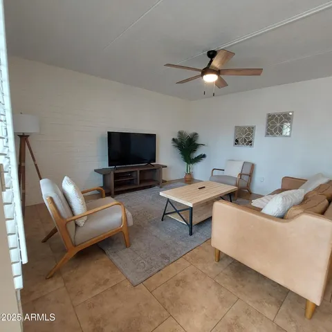 a bed room with a bed mirror and a desk