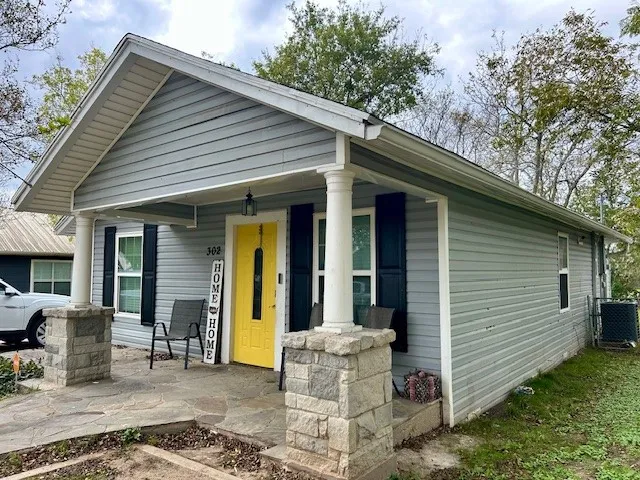 a view of a chair and tables in the patio
