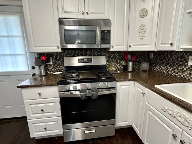 a kitchen with a stove and a microwave