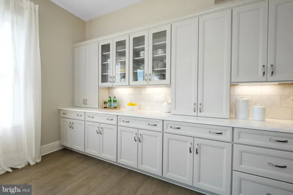 a kitchen with granite countertop white cabinets and sink