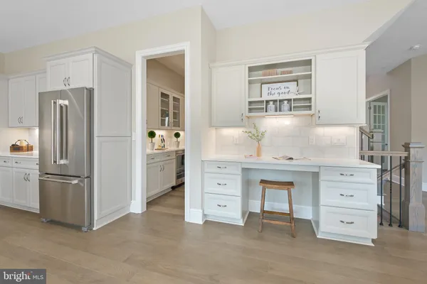 a kitchen with cabinets stainless steel appliances and a window