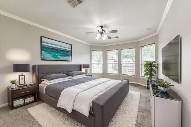 a living room with furniture a rug and a book shelf
