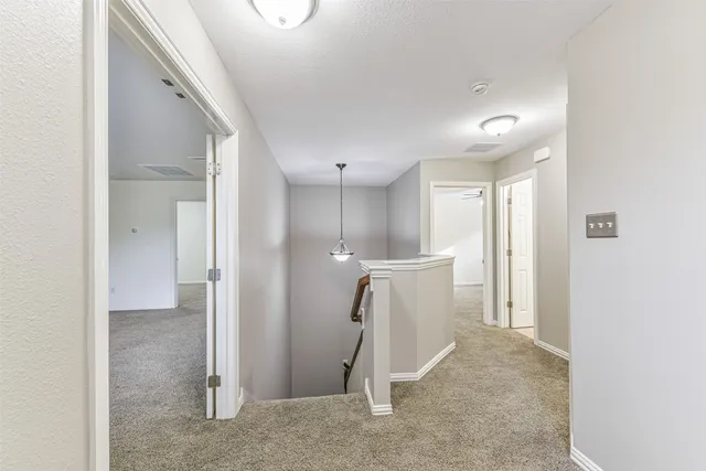 a view of staircase with white walls and a window