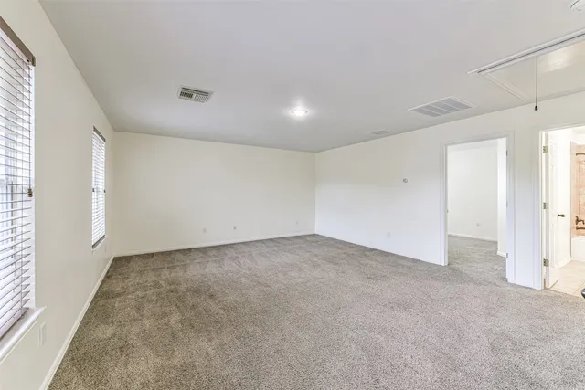 an empty room with windows and closet