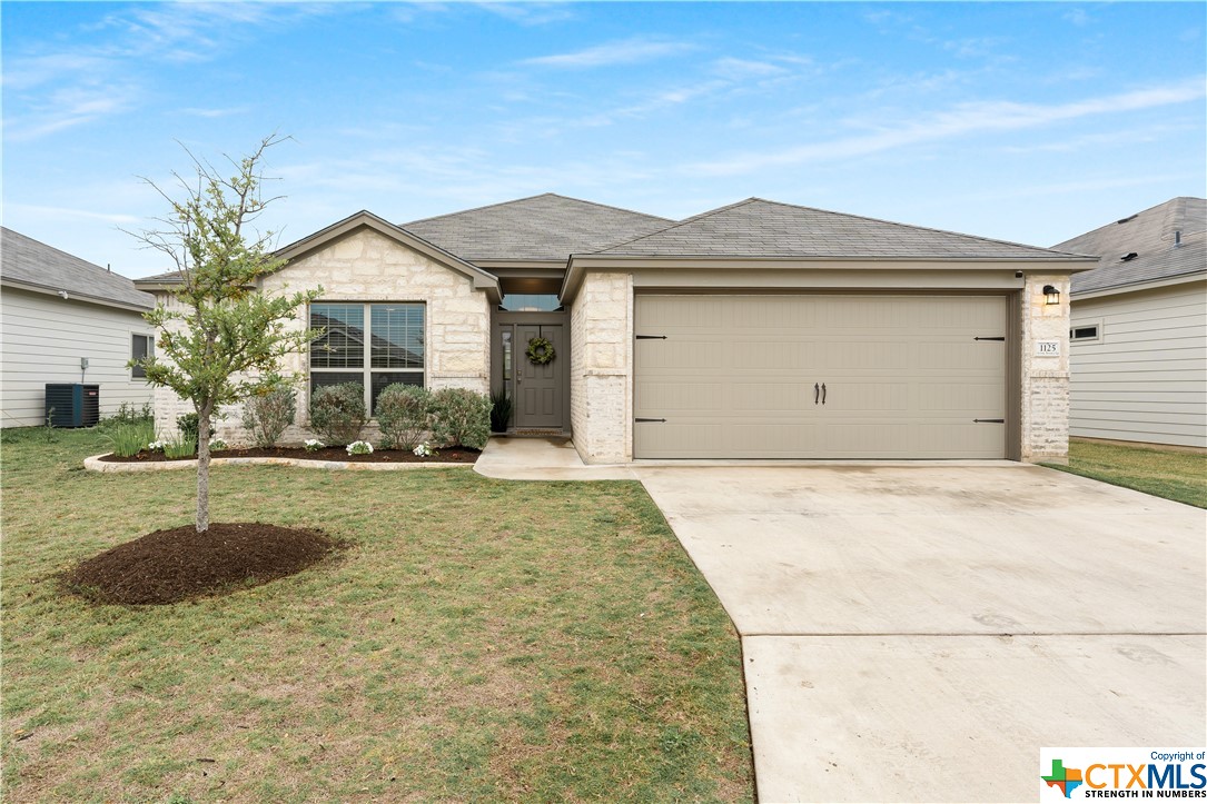 a view of a house with a yard and garage