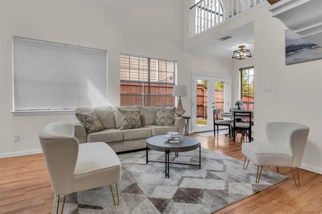 a living room with furniture a rug and a window