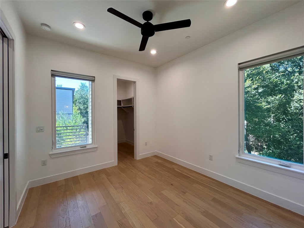 4010 Clawson Road, Unit 11 Austin, TX 78704 - Photo 3 of 19 an empty room with wooden floor fan and windows