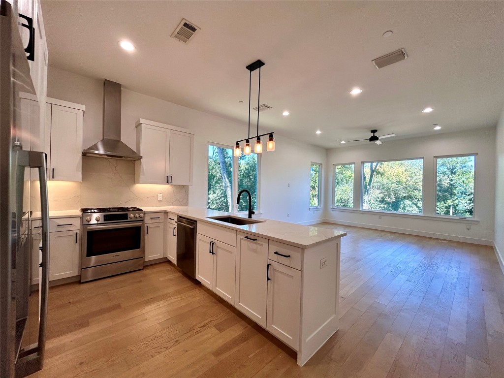 4010 Clawson Road, Unit 11 Austin, TX 78704 - Photo 6 of 19 a large kitchen with stainless steel appliances granite countertop a stove a sink and a wooden floors
