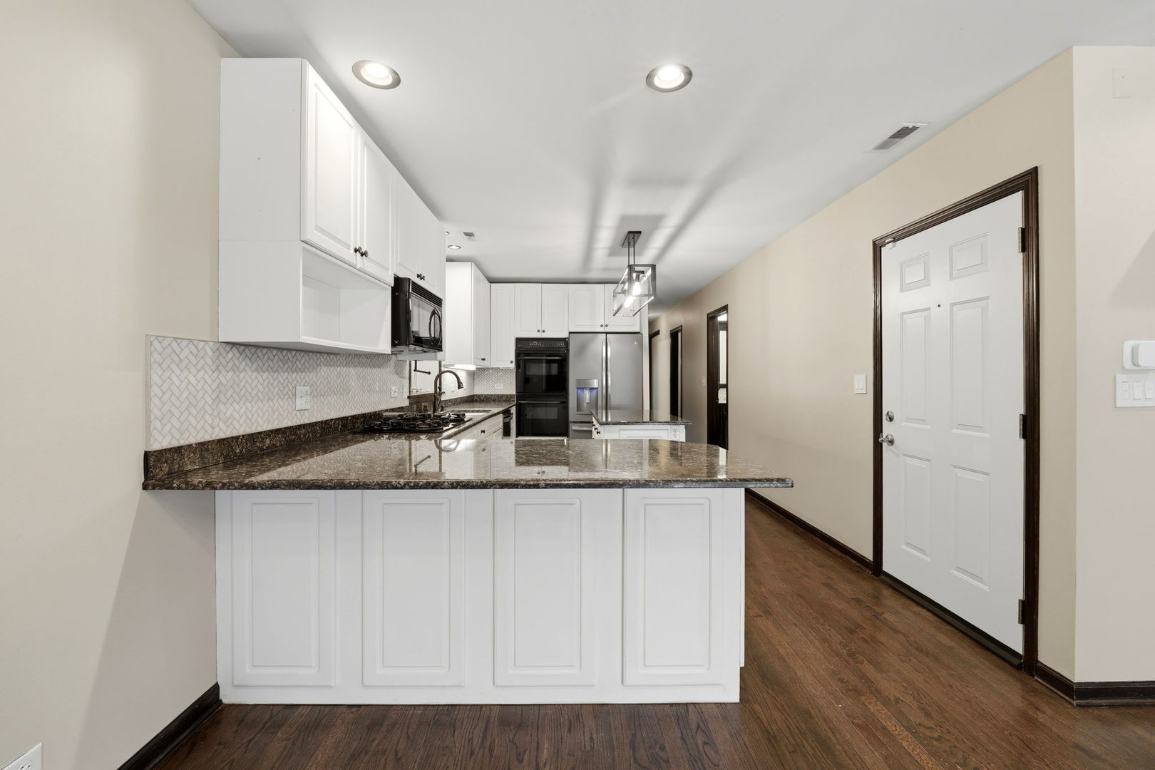 619 North Racine Avenue, Unit 1 Chicago, IL 60642 - Photo 14 of 36 a kitchen with stainless steel appliances granite countertop a sink and cabinets