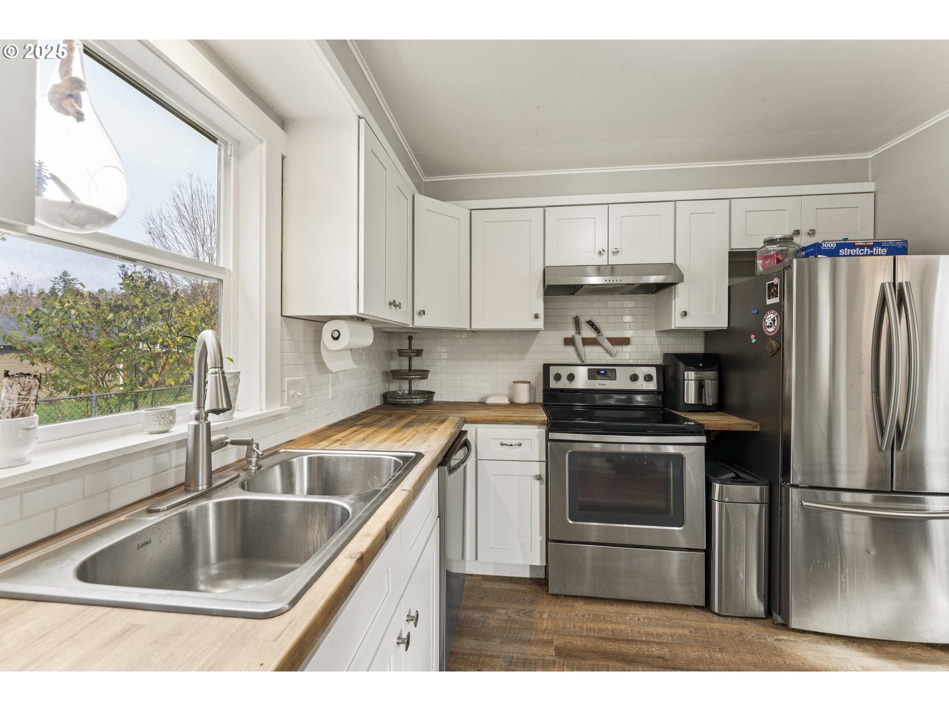411 Lane Street Silverton, OR 97381 - Photo 4 of 21 a kitchen with kitchen island a sink and a stove