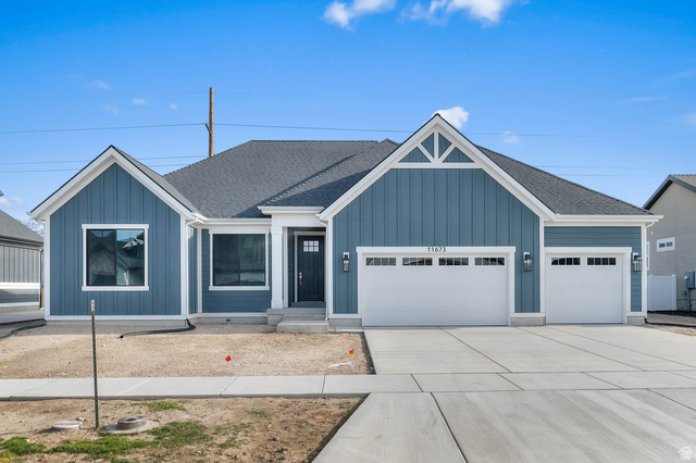 Contemporary single-story residence featuring blue board and batten siding with white trim accents