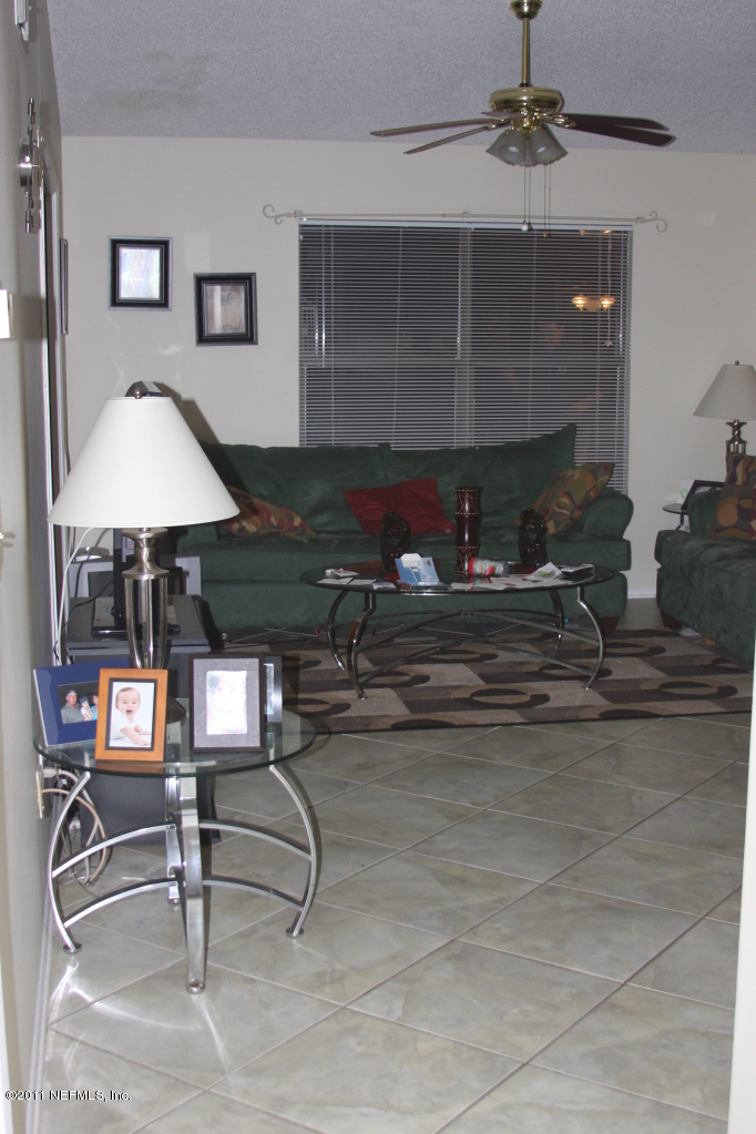 3417 Ricky Court Jacksonville, FL 32223 - Photo 3 of 16 a room with lots of chairs and chandelier