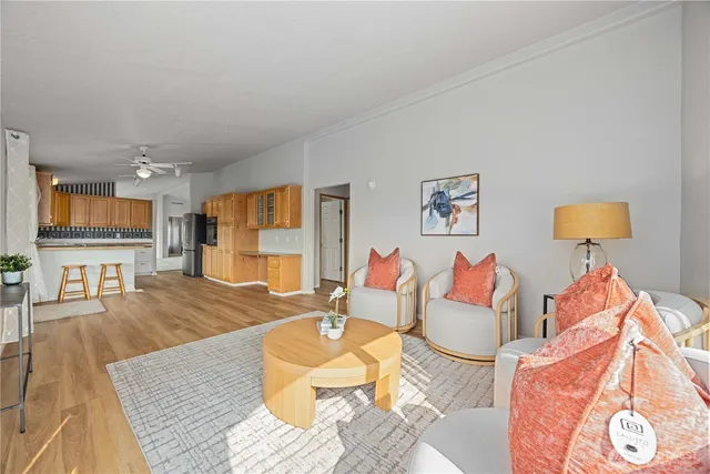 a living room with furniture and a wooden floor