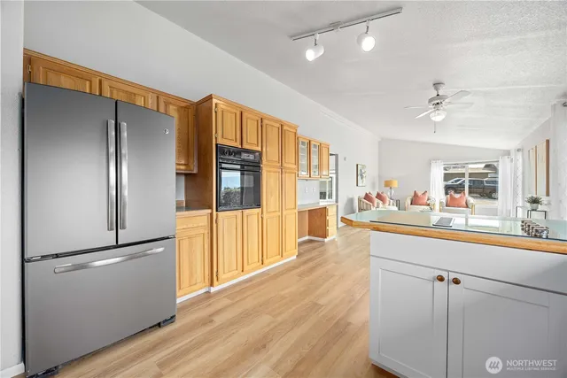 a large white kitchen with a large window