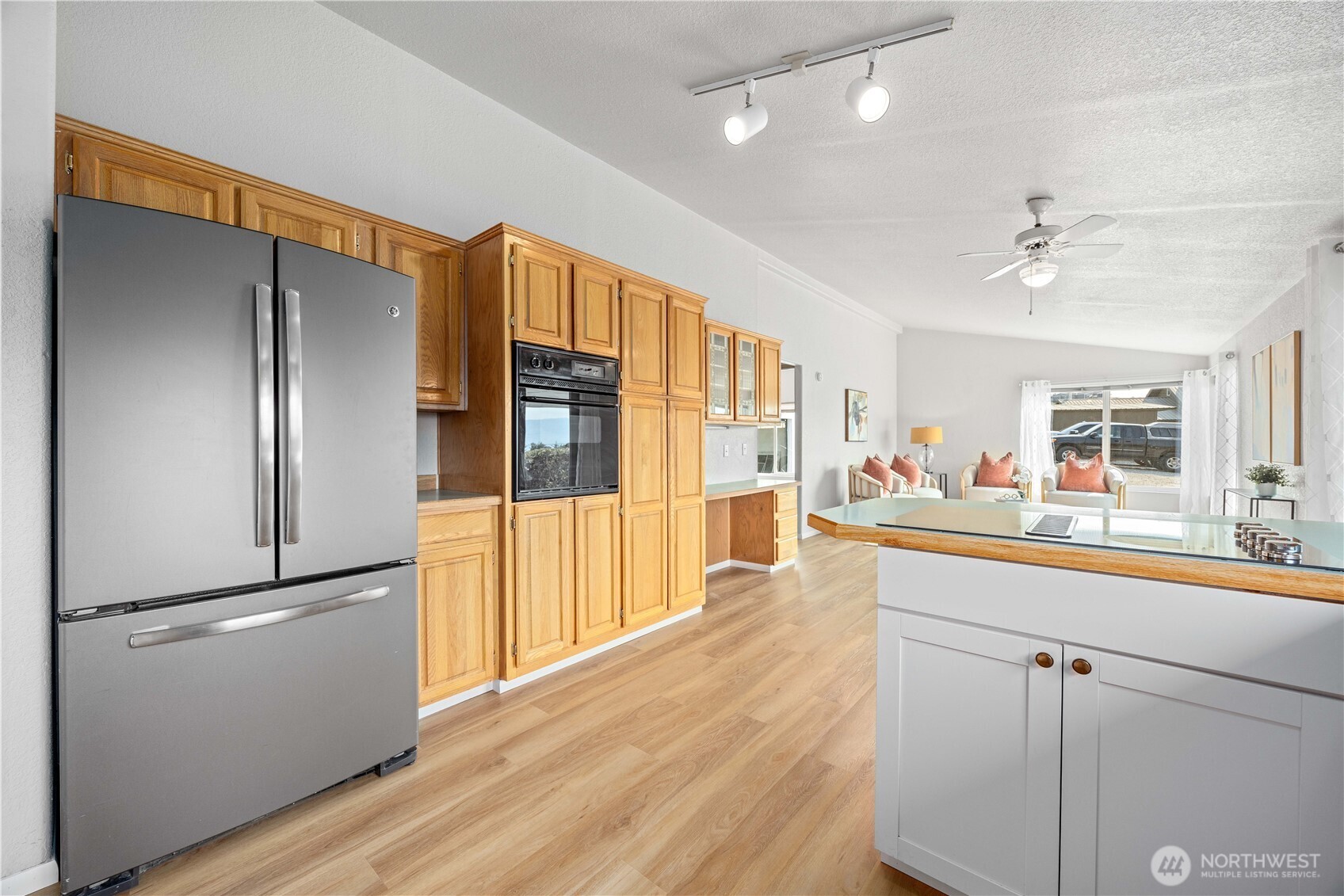 744 Wapato Lake Road Manson, WA 98831 - Photo 24 of 40 a kitchen with stainless steel appliances a refrigerator and a wooden floor