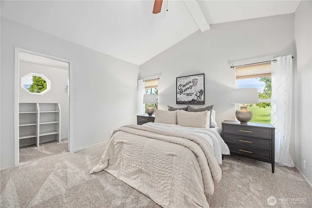 a bedroom with a bed and a window