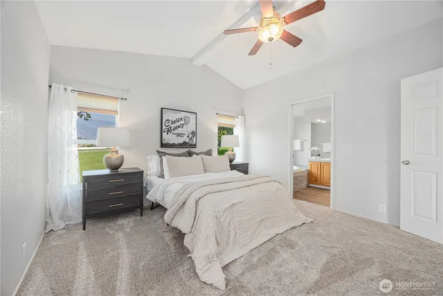 a bedroom with a bed and ceiling fan