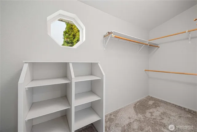 a view of walk in closet with empty racks