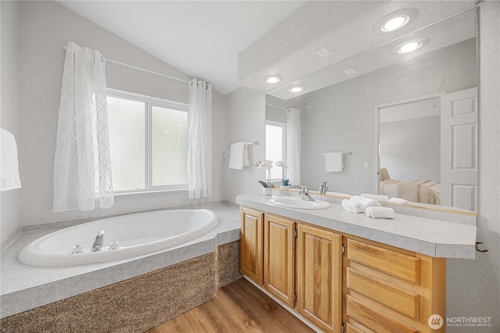 744 Wapato Lake Road Manson, WA 98831 - Photo 8 of 40 a bathroom with a tub sink and mirror