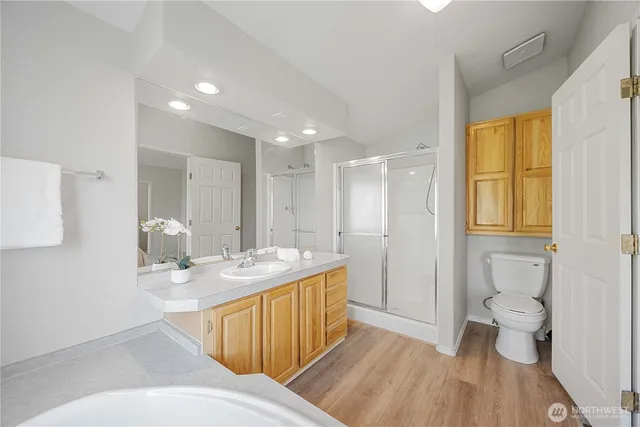 a bathroom with a granite countertop sink a toilet and a mirror