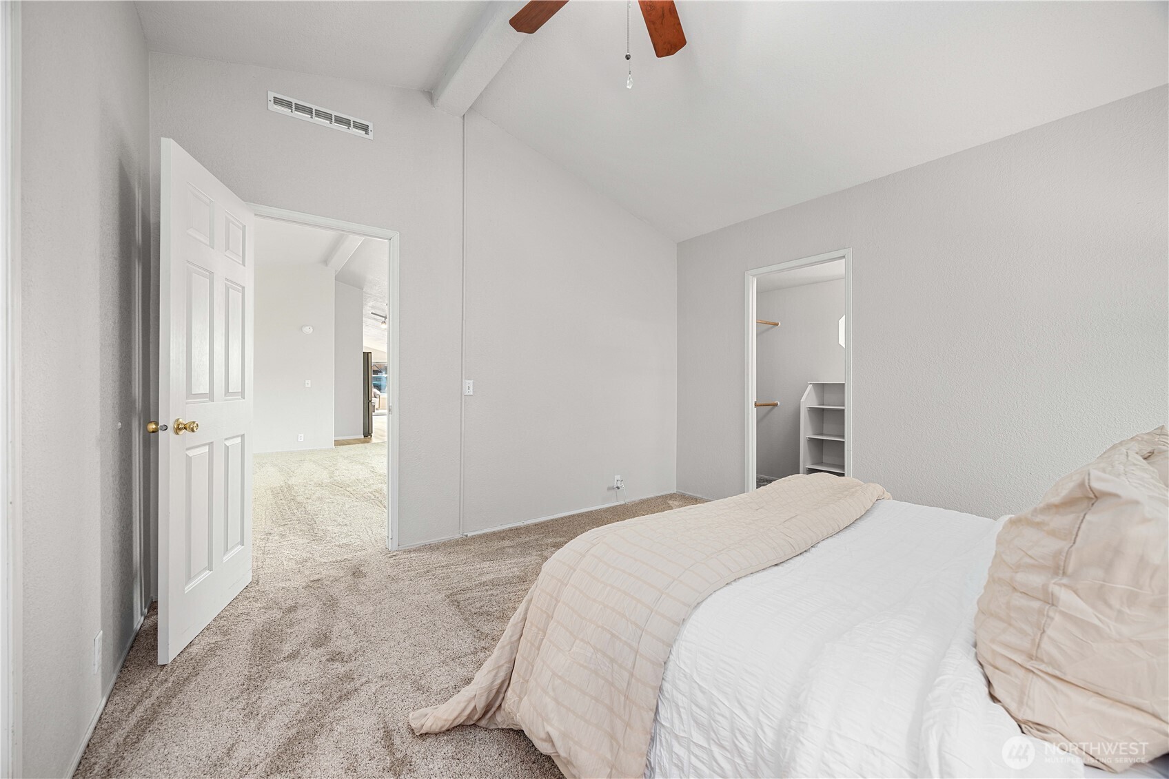 744 Wapato Lake Road Manson, WA 98831 - Photo 10 of 40 a bedroom with a bed and a chandelier