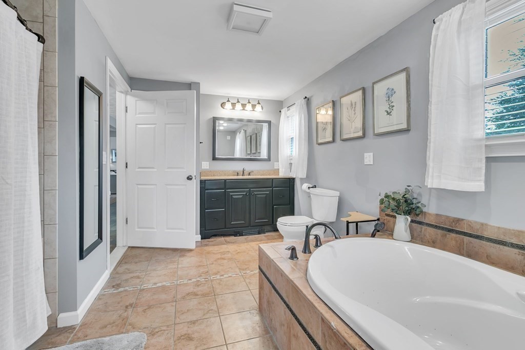 26 Queen Street Enfield, CT 06082 - Photo 23 of 40 a spacious bathroom with a tub sink and mirror