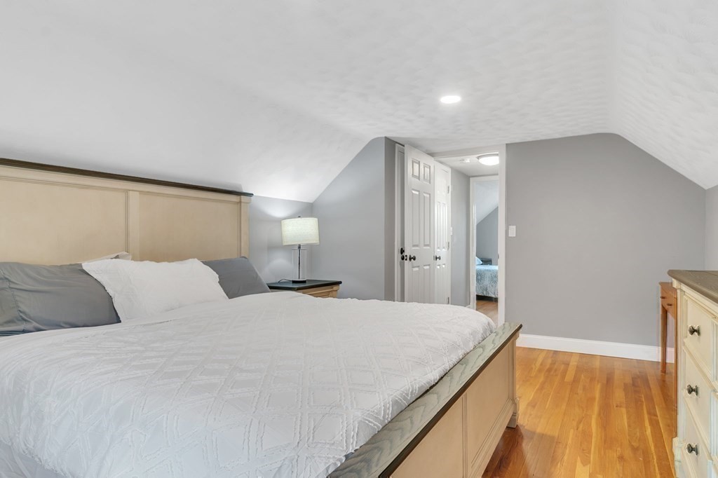 26 Queen Street Enfield, CT 06082 - Photo 25 of 40 a bedroom with a bed and a chandelier