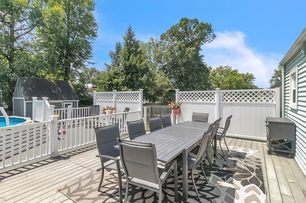 26 Queen Street Enfield, CT 06082 - Photo 32 of 40 a view of a dinning table and chairs on deck with wooden floor