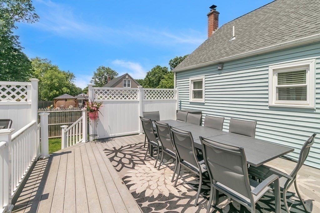 26 Queen Street Enfield, CT 06082 - Photo 33 of 40 a view of a roof deck with table and chairs with wooden floor and fence
