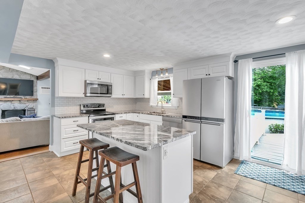 26 Queen Street Enfield, CT 06082 - Photo 5 of 40 a kitchen with white cabinets and stainless steel appliances