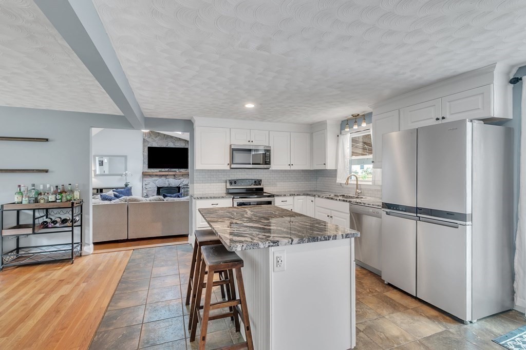 26 Queen Street Enfield, CT 06082 - Photo 6 of 40 a kitchen with stainless steel appliances granite countertop a refrigerator stove microwave and sink