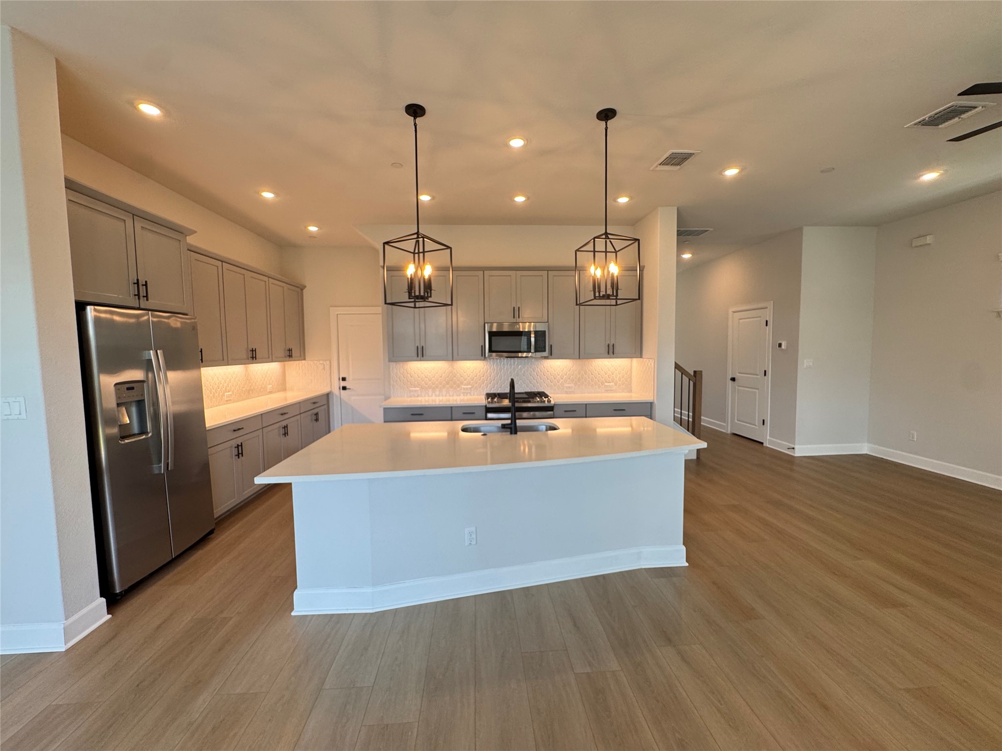 3000 Chisholm Trail Road, Unit 63 Round Rock, TX 78681 - Photo 3 of 31 An open-concept kitchen with a substantial island and gleaming stainless steel appliances awaits culinary exploration.