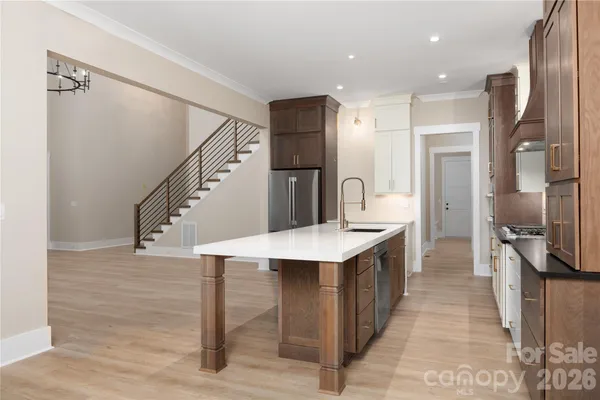 a kitchen with granite countertop a sink a stove and cabinets