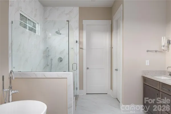 a bathroom with a bathtub and a shower