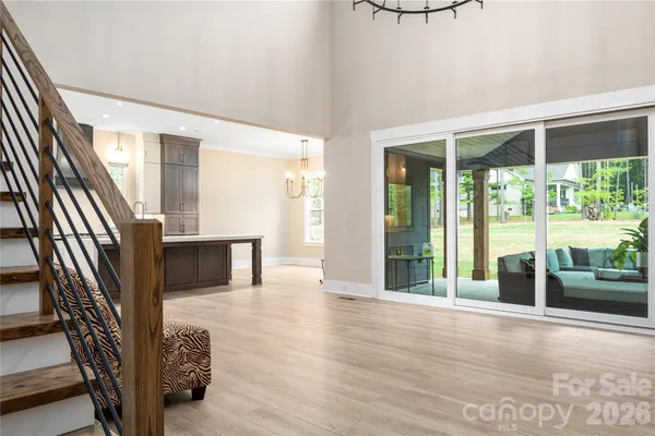 a kitchen with kitchen island granite countertop a refrigerator and a sink