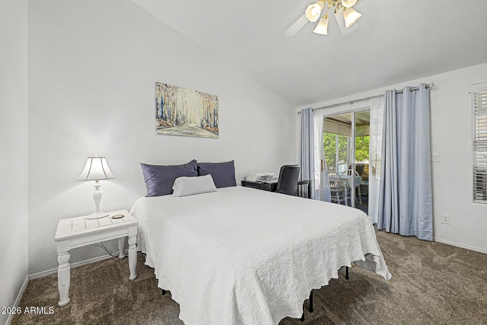 2550 South Ellsworth Road, Unit 46 Mesa, AZ 85209 - Photo 16 of 46 a bedroom with a bed and a chandelier